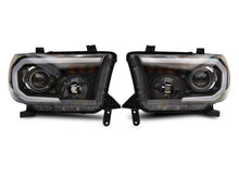 Load image into Gallery viewer, Raxiom 07-13 Toyota Tundra Axial Projector Headlights w/ SEQL LED Bar- Blk Housing (Clear Lens)